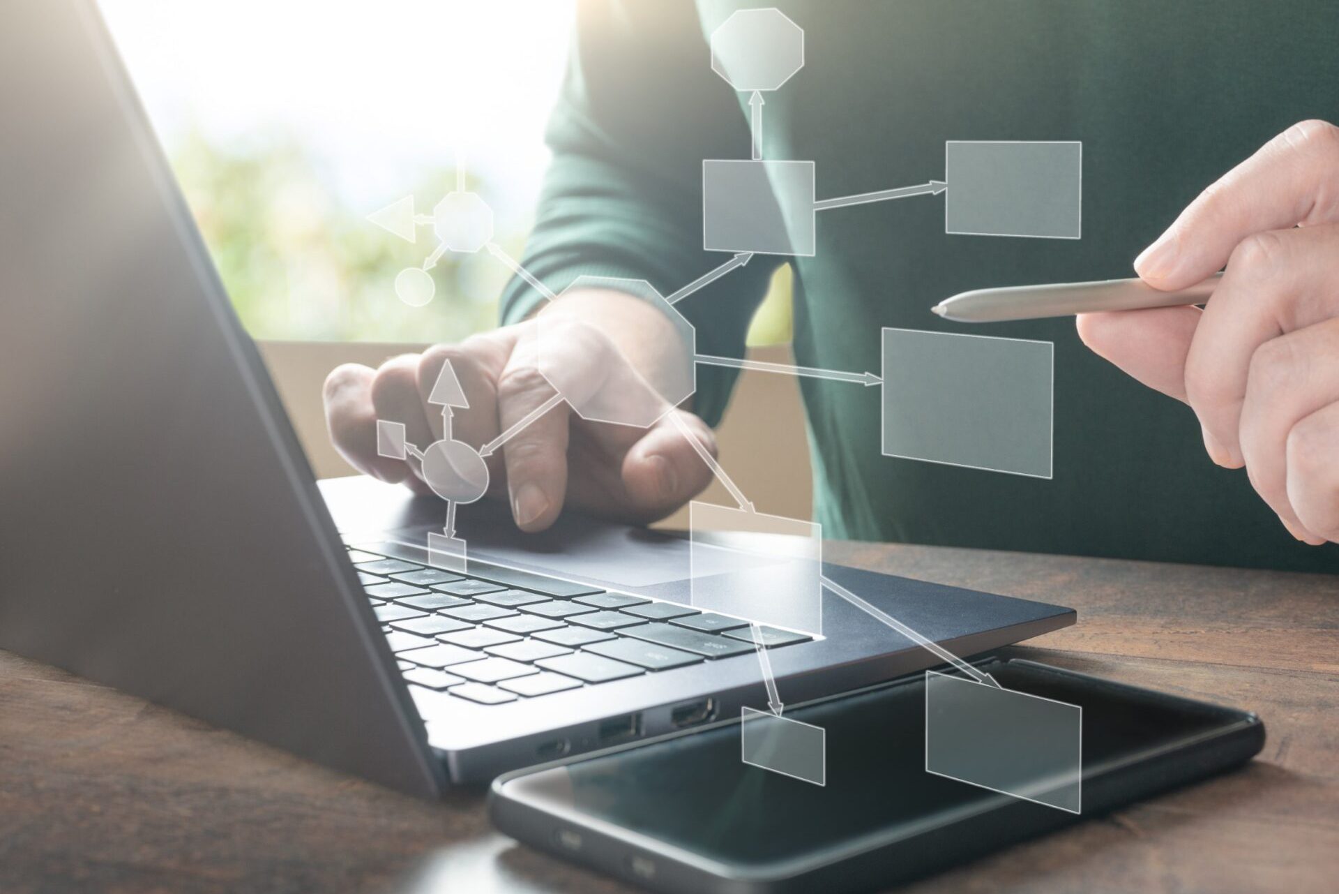 businessman using laptop develops an interaction block diagram of algorithm in his company. algorithm, business scheme. digital marketing, investment on global business